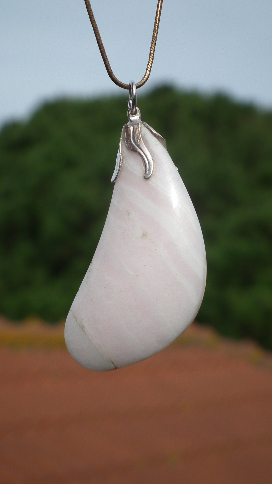 Mangano calcite pendant with silverplated